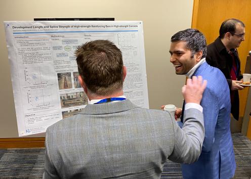 Student presenting research to attendee 