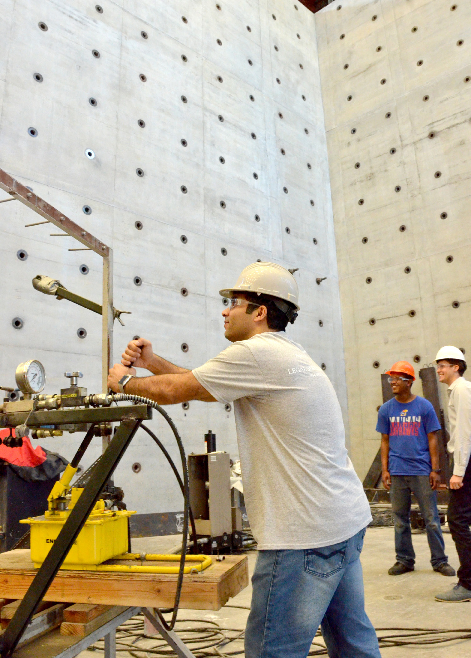 People with hard hats in the structural testing facility