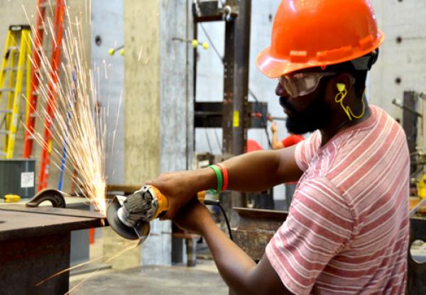a person works with an angle grinder