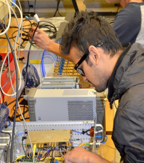 A student affixes wires on an angled surface